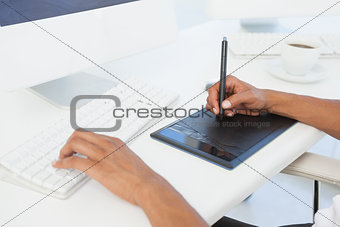 Designer working at desk using digitizer
