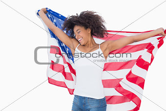 Pretty girl wrapped in american flag cheering