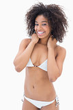 Athletic girl in white bikini smiling at camera