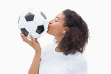 Pretty girl kissing her football