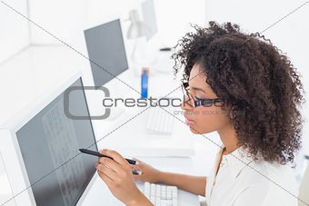 Focused casual editor working at desk