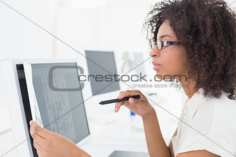 Pretty photo editor working on computer at desk