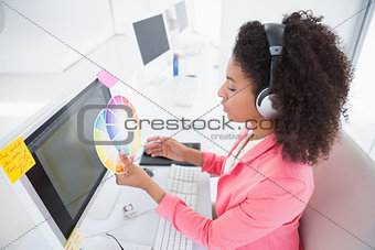 Casual graphic designer working at her desk