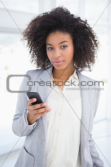 Casual businesswoman texting on phone