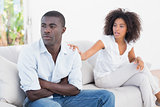 Attractive couple having an argument on couch