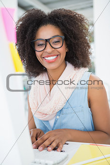 Pretty young hipster businesswoman smiling at camera