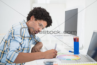 Young designer working at his desk