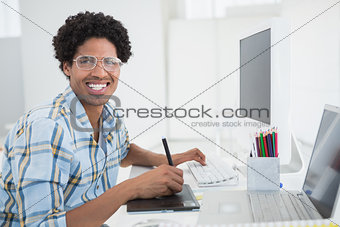 Young designer working at his desk with digitizer