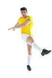 Football player in yellow jersey kicking