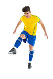 Football player in yellow kicking