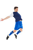 Football player in blue jersey jumping