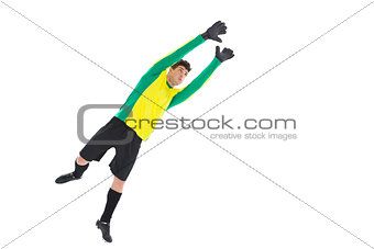 Goalkeeper in yellow jumping up