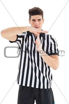 Stern referee showing time out sign
