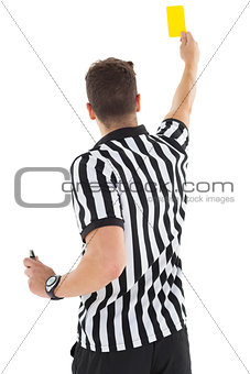 Stern referee showing yellow card