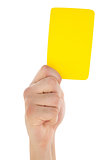 Hand holding yellow card up