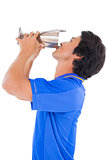 Football player in blue kissing winners cup