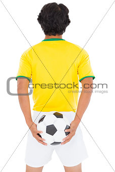 Football player in yellow holding ball
