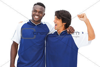 Football players in blue celebrating