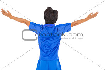 Football player in blue celebrating a victory