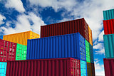 Stacked Cargo Containers on Sky Background.