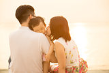 Lovely Asian family at outdoor beach