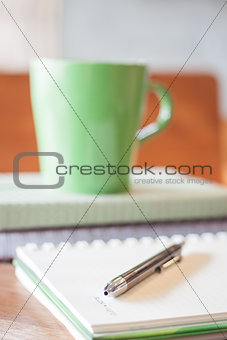 Closeup pen on green mug background