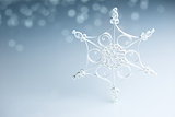 Beautiful white handmade quilling snowflake on blue - horizontal