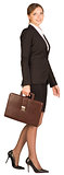 Businesswoman walks holding briefcase in his hand