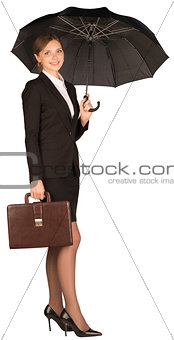 Businesswoman holding a briefcase and umbrella