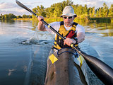 senior male paddler training in a fast sea kayak