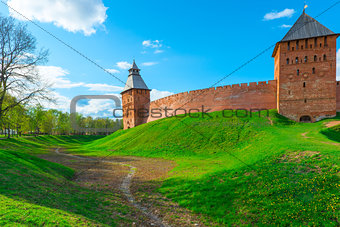 green lawn and a moat around the walls of the Novgorod Kremlin