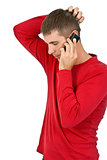 man in a red dress speaks on a mobile phone.