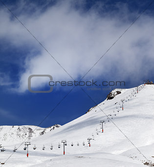 Chair-lift and ski slope in sun day