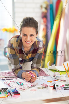 Portrait of smiling tailor in studio