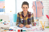 Portrait of happy dressmaker woman at work