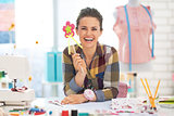 Portrait of smiling dressmaker woman in studio