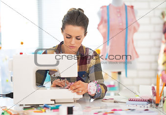 Dressmaker woman working with sewing machine