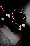 red wine glass near bottle