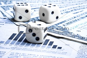 dice on financial chart near dollars