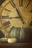 Still life of pumpkins and old clock