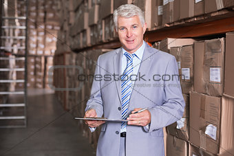Warehouse manager smiling at camera