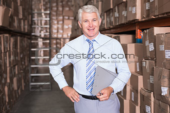 Smiling warehouse manager looking at camera