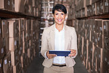 Pretty warehouse manager holding tablet pc