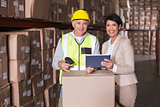 Warehouse worker scanning box with manager