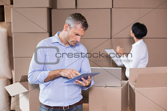 Warehouse manager using his tablet pc