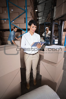 Warehouse manager using her tablet pc