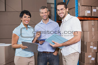Warehouse workers smiling at camera