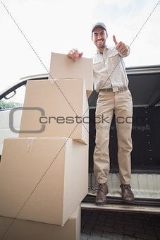 Delivery driver smiling at camera in his van