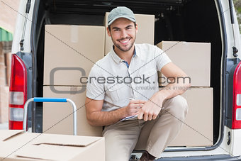 Delivery driver writing in clipboard