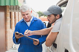 Delivery driver showing customer where to sign